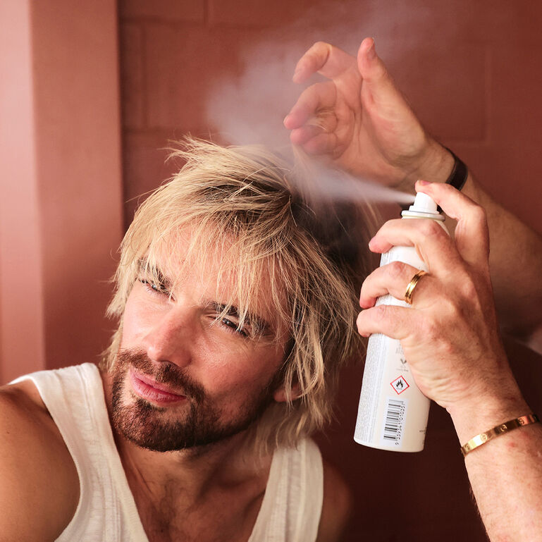 Dry shampoo product displayed with styled hair care visuals